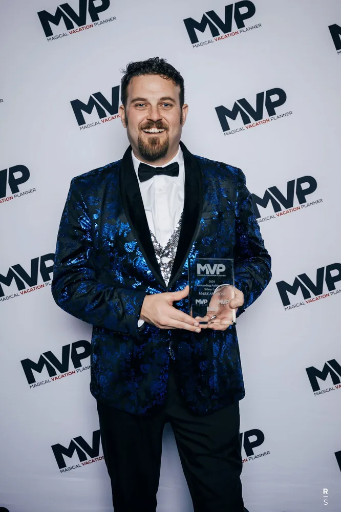 Mark Ambrose holding his MVP Sales Award in 2025